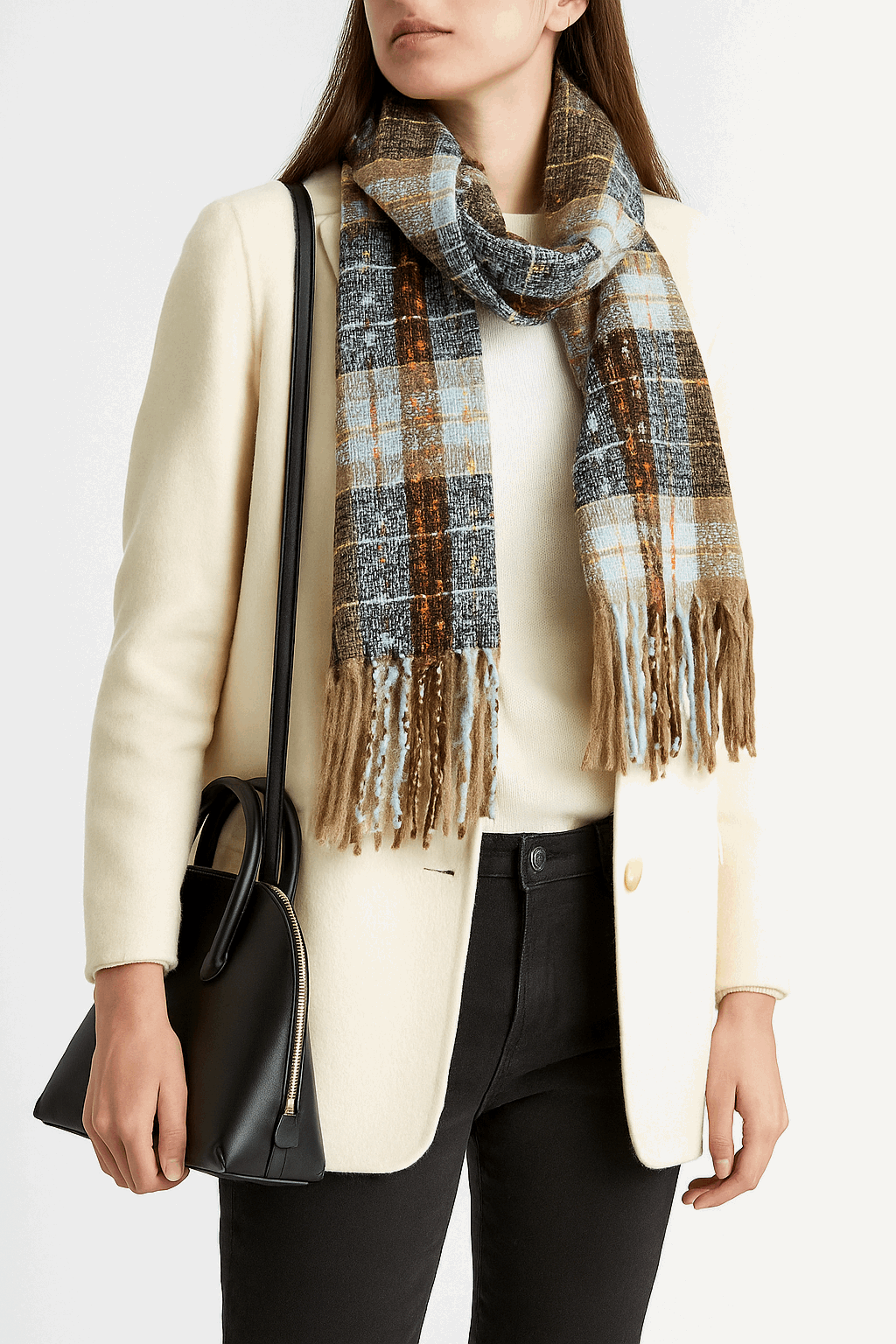 Person wearing a plaid scarf, cream coat, and black pants on a white background